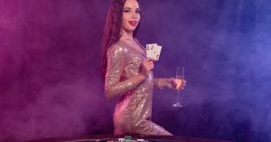 a woman holding a glass and poker cards