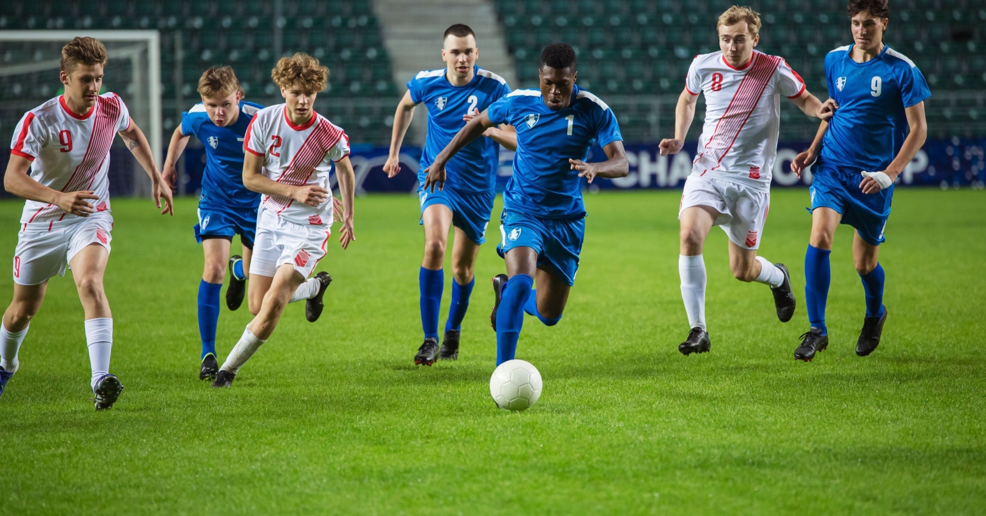 football players chasing a ball